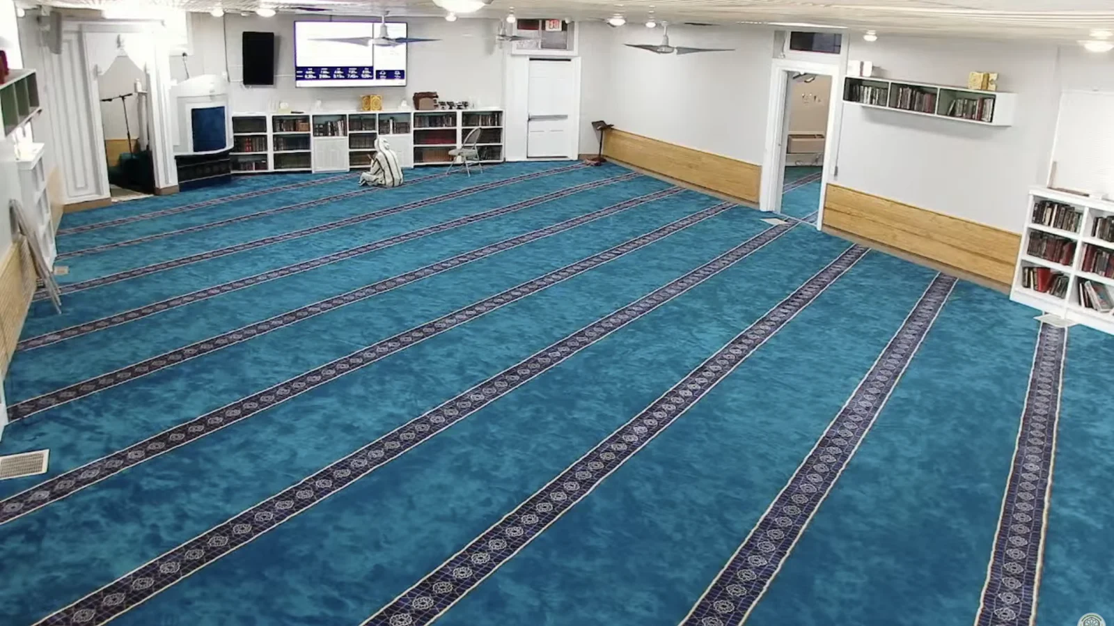 Prayer hall at Masjid Al Towbah with blue carpet and rows for worshippers
